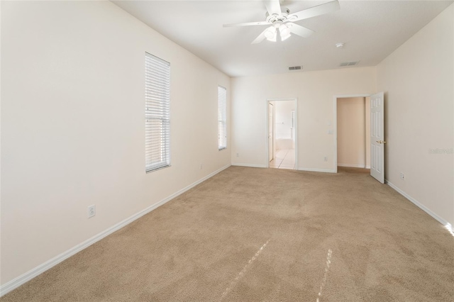 9723 Pecky Cypress Way, Orlando, FL 32836 - unfurnished bedroom with light colored carpet, ensuite bath, and a ceiling fan