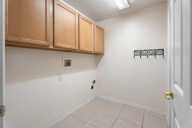 9723 Pecky Cypress Way, Orlando, FL 32836 - laundry area with cabinet space, hookup for a washing machine, hookup for an electric dryer, light tile patterned floors, and a textured ceiling