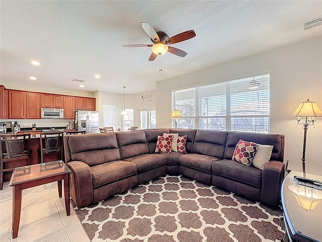 living room with recessed lighting, light tile patterned floors, visible vents, and ceiling fan