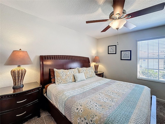 carpeted bedroom featuring baseboards, a ceiling fan, and a textured ceiling