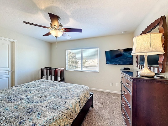 carpeted bedroom with baseboards and a ceiling fan