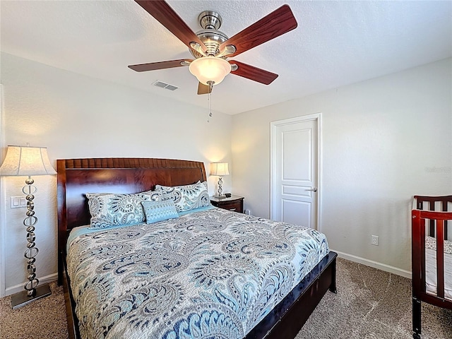 carpeted bedroom with ceiling fan, baseboards, and visible vents