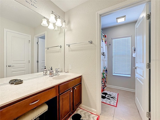 bathroom with vanity, baseboards, tile patterned flooring, and a shower with curtain