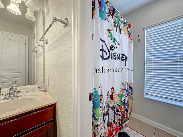 bathroom with tile patterned floors, vanity, and a shower with curtain