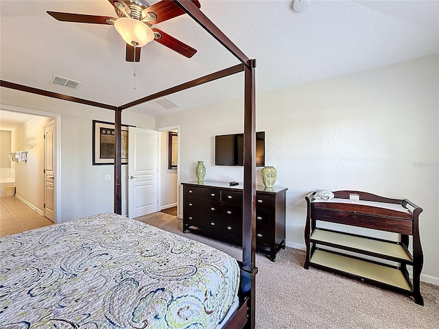 carpeted bedroom featuring visible vents, baseboards, a ceiling fan, and connected bathroom