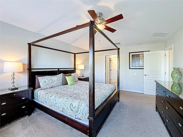 carpeted bedroom featuring visible vents, a textured ceiling, baseboards, and ceiling fan