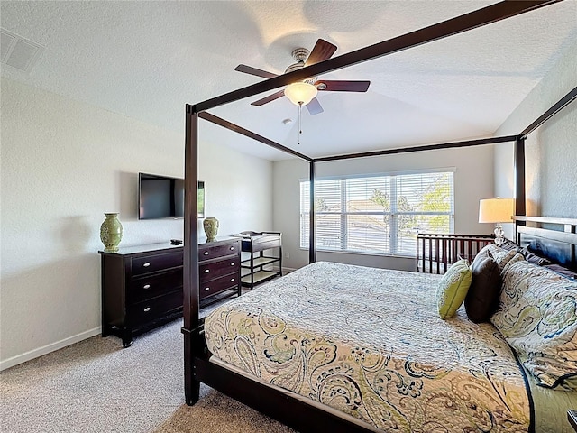 bedroom featuring visible vents, baseboards, ceiling fan, carpet floors, and vaulted ceiling