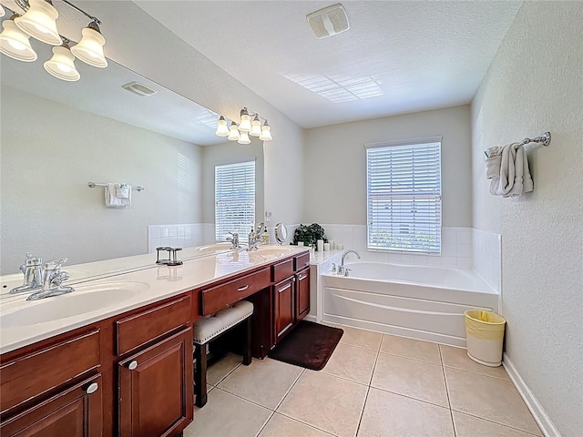 full bath featuring a garden tub, tile patterned flooring, visible vents, a sink, and double vanity