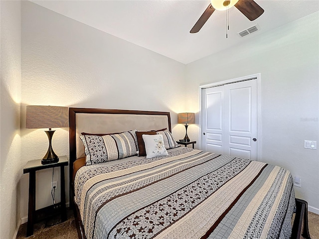 bedroom featuring a closet, a ceiling fan, visible vents, carpet floors, and baseboards