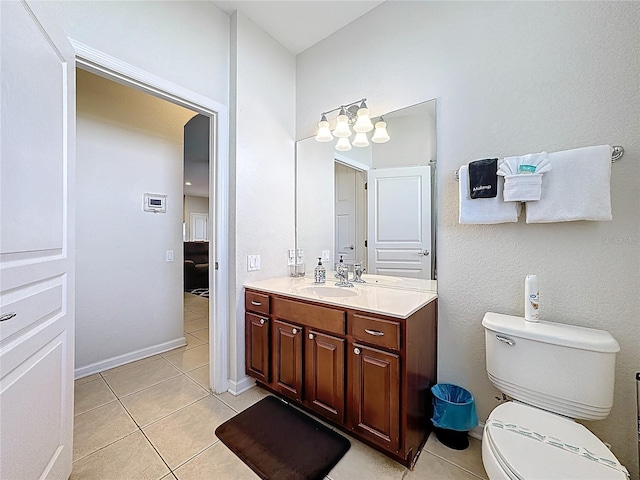 bathroom featuring toilet, vanity, and tile patterned flooring