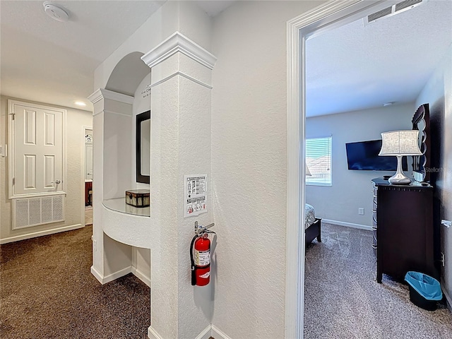 hall featuring ornate columns, carpet flooring, baseboards, and visible vents