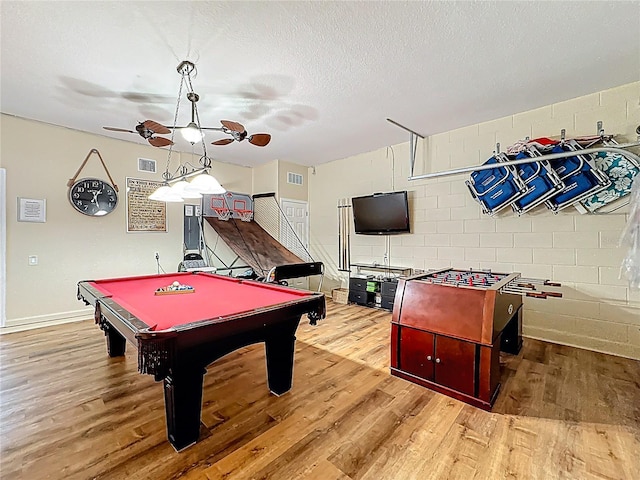 rec room featuring visible vents, ceiling fan, concrete block wall, wood finished floors, and pool table