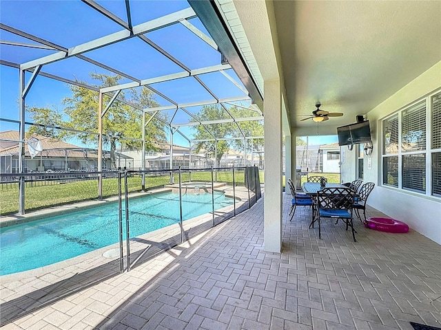 view of pool with a patio, a lanai, ceiling fan, a pool with connected hot tub, and fence