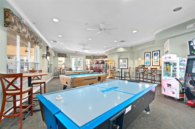 recreation room with crown molding, recessed lighting, dark colored carpet, and a ceiling fan