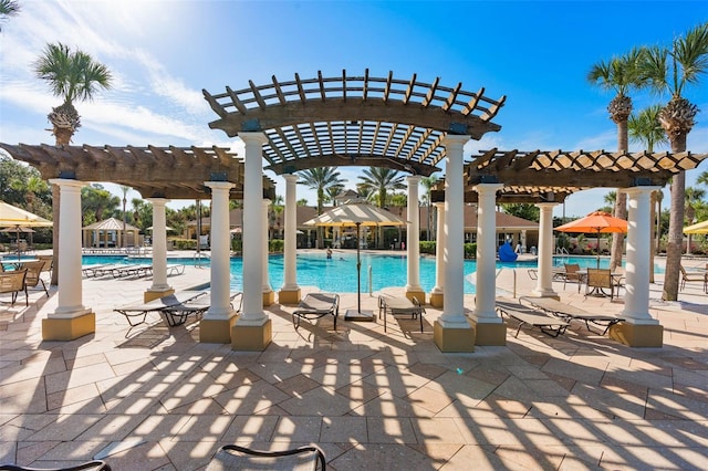 community pool with a patio and a pergola