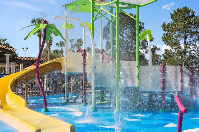 view of property's community with fence and playground community