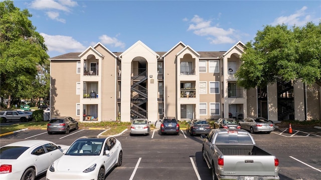 view of building exterior with uncovered parking