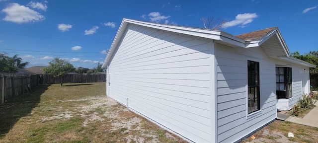 view of home's exterior with a yard and a fenced backyard