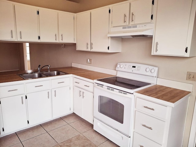 kitchen with a sink, under cabinet range hood, light tile patterned flooring, white cabinetry, and white electric stove