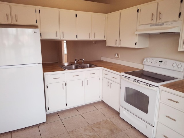 kitchen featuring under cabinet range hood, white appliances, a sink, and light tile patterned floors