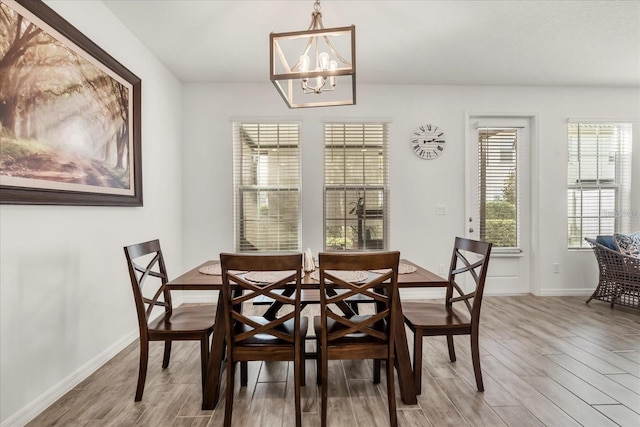 2710 Bolzano Dr, Apopka, FL 32712 - dining space featuring a notable chandelier, baseboards, and wood finished floors