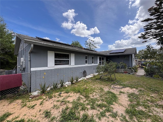 3219 Chariot Pl, Orlando, FL 32818 - view of front of property featuring concrete block siding and solar panels