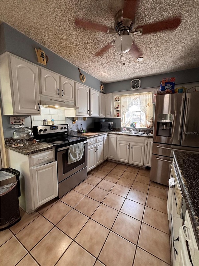 3219 Chariot Pl, Orlando, FL 32818 - kitchen featuring appliances with stainless steel finishes, a sink, white cabinets, and under cabinet range hood