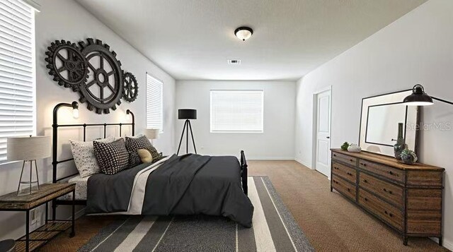 bedroom with baseboards, visible vents, and carpet floors