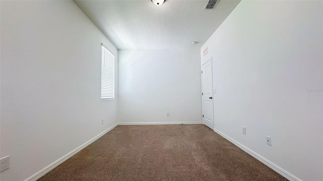 unfurnished room featuring a textured ceiling, baseboards, visible vents, and carpet floors