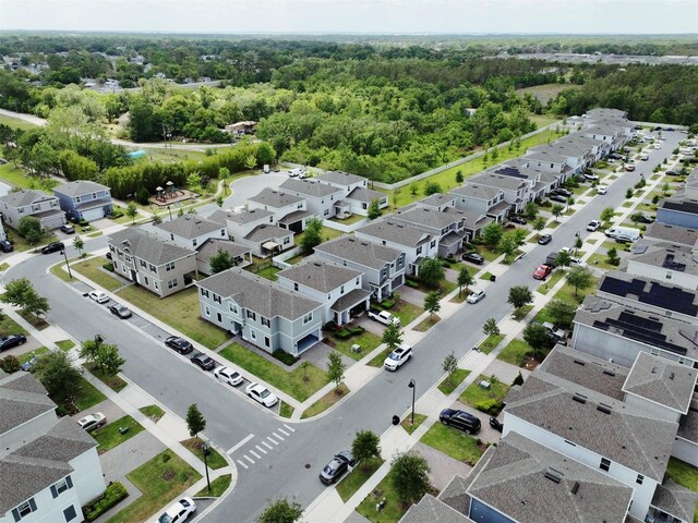 birds eye view of property with a forest view and a residential view