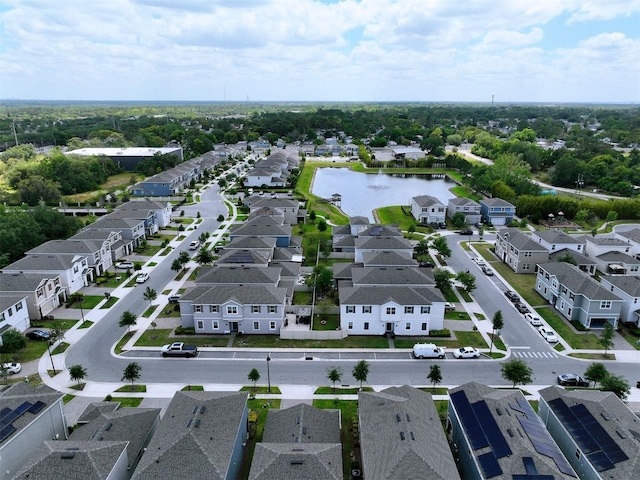 drone / aerial view featuring a water view and a residential view