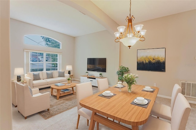 dining space featuring light colored carpet, an inviting chandelier, visible vents, and baseboards