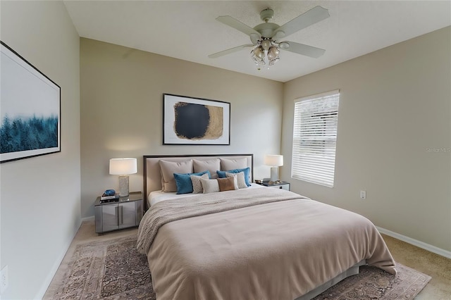 bedroom featuring light carpet, baseboards, and ceiling fan