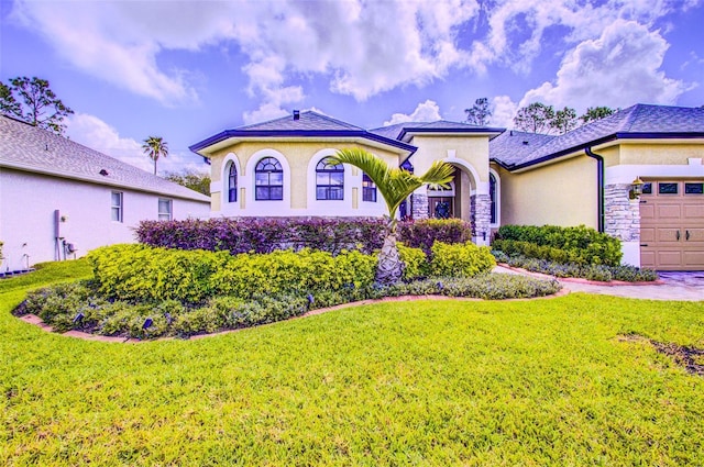 2626 Greenwillow Dr, Orlando, FL 32825 - mediterranean / spanish-style home featuring a front yard, stucco siding, and a garage