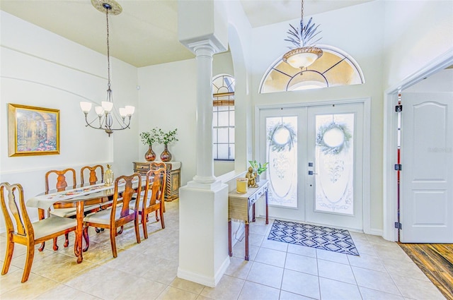 2626 Greenwillow Dr, Orlando, FL 32825 - foyer with a chandelier, decorative columns, light tile patterned flooring, and arched walkways