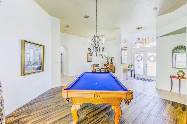 2626 Greenwillow Dr, Orlando, FL 32825 - recreation room featuring arched walkways, a chandelier, wood finished floors, billiards table, and baseboards