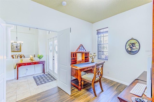 2626 Greenwillow Dr, Orlando, FL 32825 - office featuring wood finished floors, plenty of natural light, a chandelier, french doors, and a textured ceiling