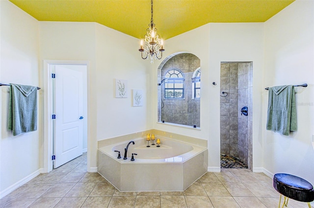 2626 Greenwillow Dr, Orlando, FL 32825 - full bath with a chandelier, tile patterned floors, walk in shower, and a garden tub