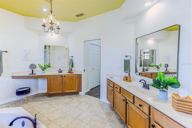 2626 Greenwillow Dr, Orlando, FL 32825 - full bath with tile patterned flooring, two vanities, baseboards, a bathtub, and a chandelier