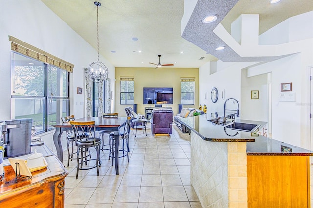2626 Greenwillow Dr, Orlando, FL 32825 - kitchen with a sink, recessed lighting, a ceiling fan, light tile patterned floors, and a chandelier