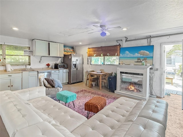 340 Zelda Blvd, Daytona Beach, FL 32118 - living area featuring plenty of natural light, ceiling fan, recessed lighting, and a glass covered fireplace