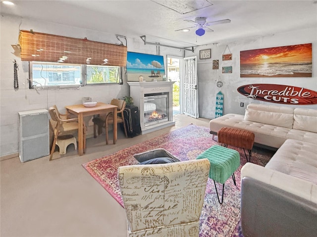 340 Zelda Blvd, Daytona Beach, FL 32118 - living area with healthy amount of natural light, ceiling fan, a glass covered fireplace, and finished concrete flooring