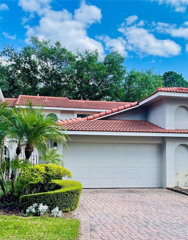 garage with decorative driveway
