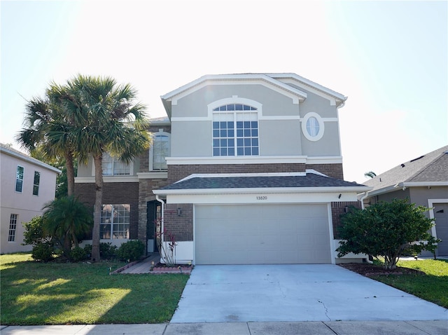 13520 Meadow Bay Loop, Orlando, FL 32824 - traditional home with a garage, stucco siding, a front yard, brick siding, and driveway