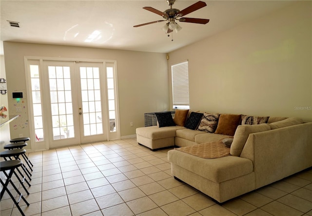 13520 Meadow Bay Loop, Orlando, FL 32824 - living area featuring a ceiling fan, light tile patterned flooring, a healthy amount of sunlight, and visible vents