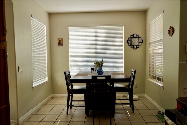 13520 Meadow Bay Loop, Orlando, FL 32824 - dining area with light tile patterned flooring and baseboards