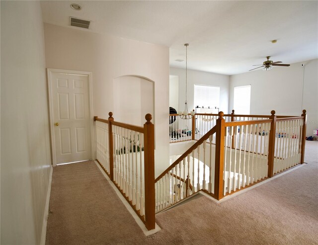 13520 Meadow Bay Loop, Orlando, FL 32824 - corridor featuring visible vents, an upstairs landing, and carpet floors