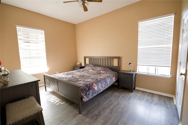 13520 Meadow Bay Loop, Orlando, FL 32824 - bedroom featuring baseboards, wood finished floors, and ceiling fan