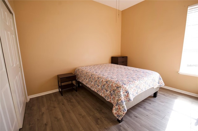 13520 Meadow Bay Loop, Orlando, FL 32824 - bedroom with multiple windows, dark wood-style flooring, and baseboards