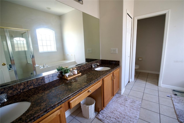 13520 Meadow Bay Loop, Orlando, FL 32824 - bathroom featuring double vanity, a sink, a stall shower, and tile patterned flooring